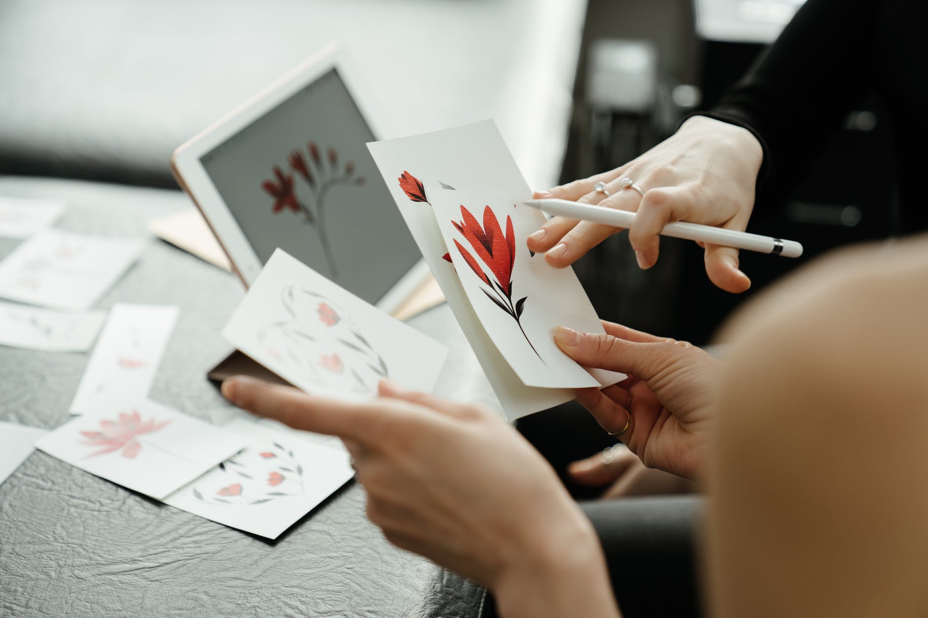 person holding white and red card